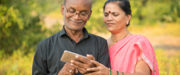 Older couple smiling at phone