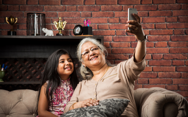 Senior woman taking a selfie with granddaughter